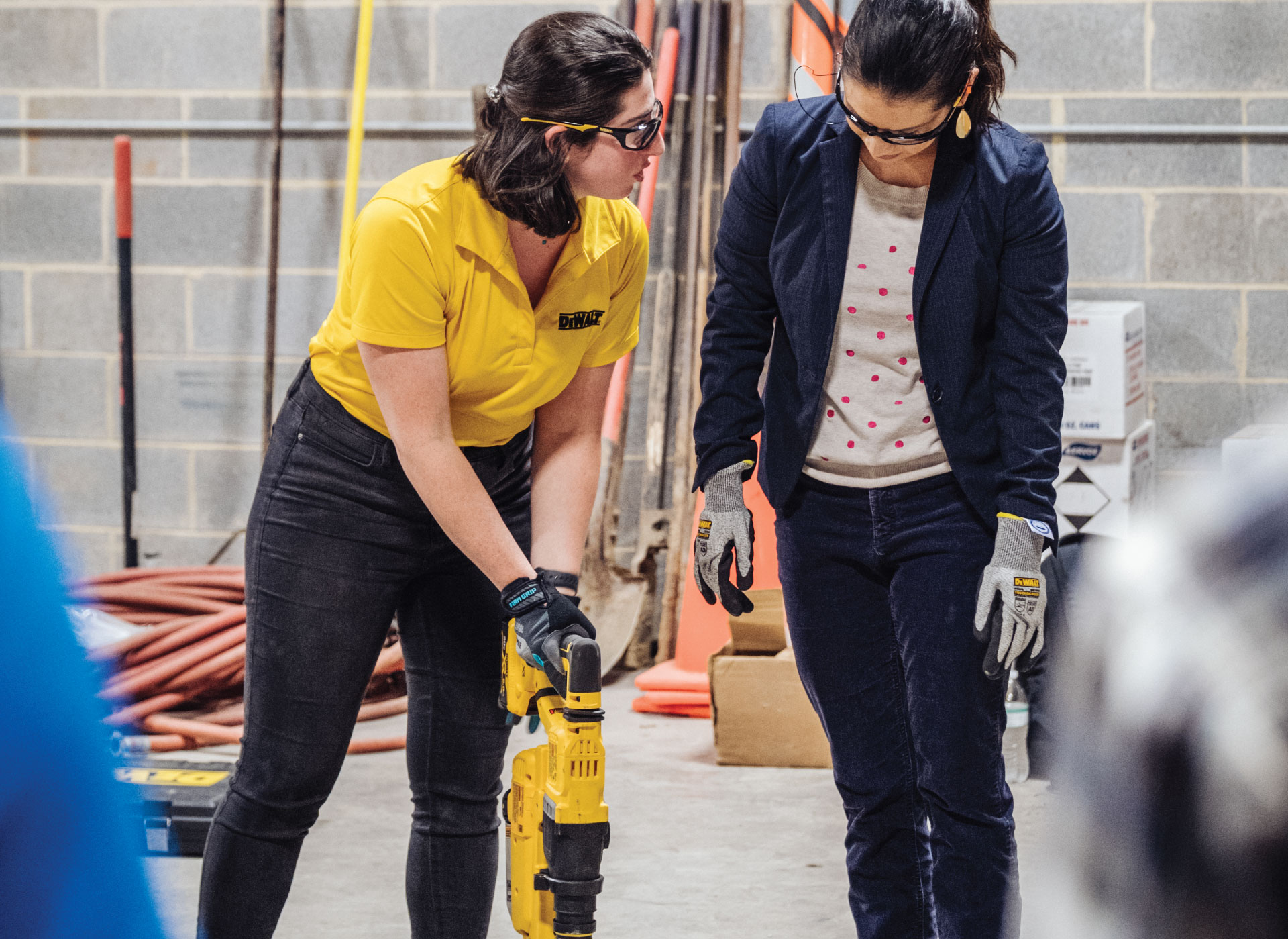 Two women demoing a DEWALT product