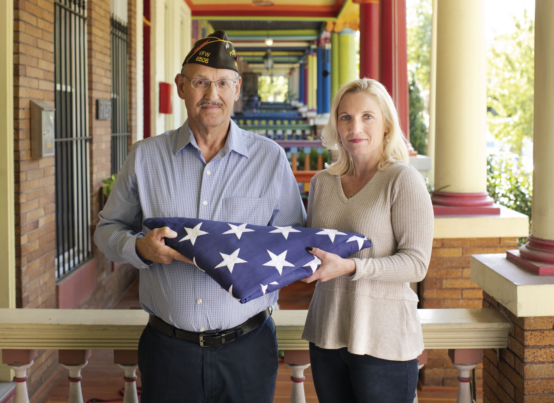 Two people holding the American flag