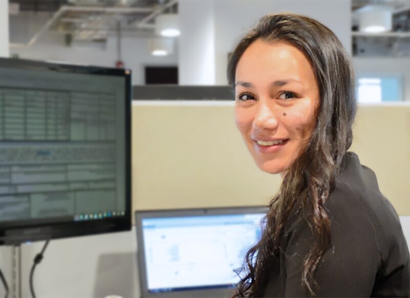 Stanley Black & Decker employee sitting in front of her computer in a cubicle