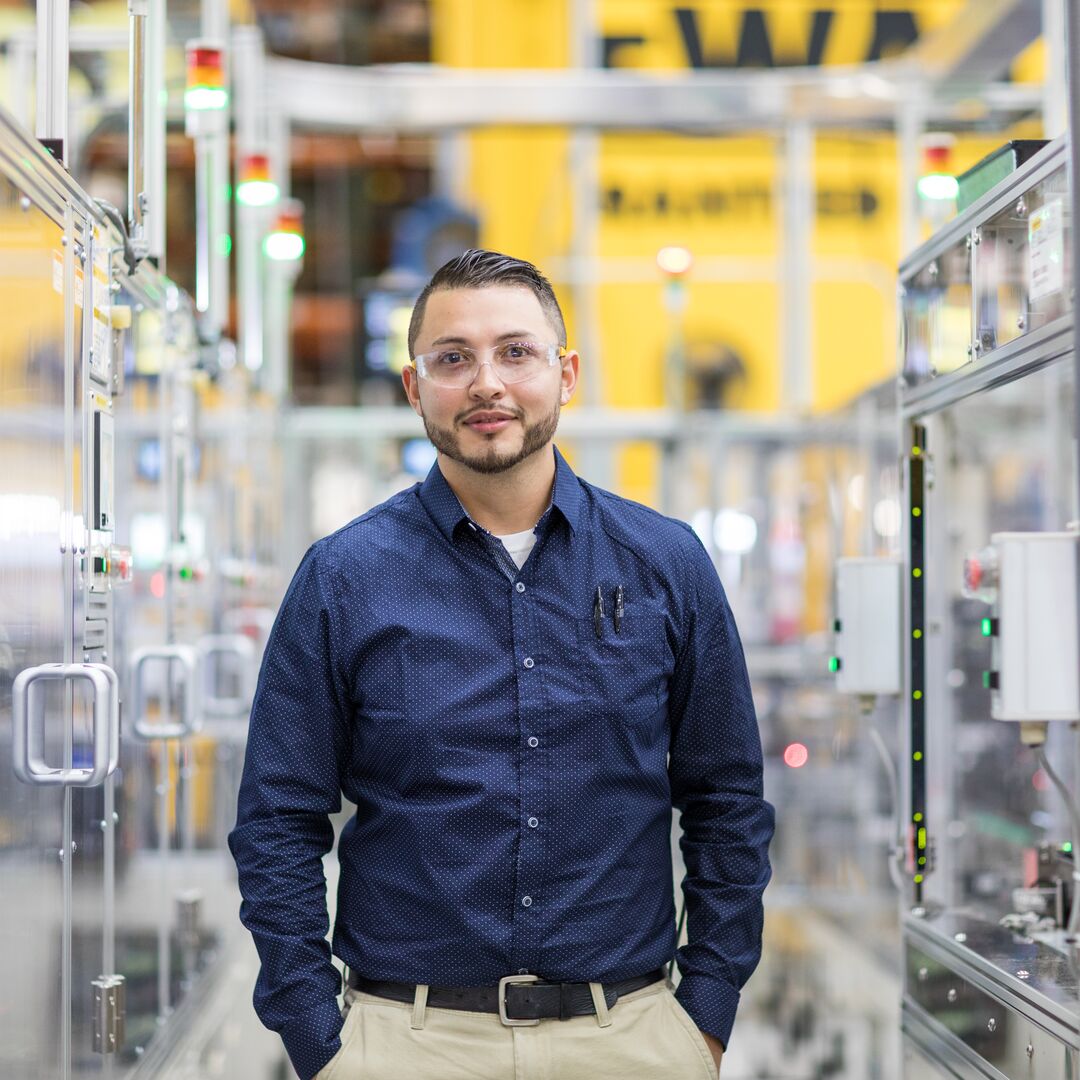 A Stanley Black & Decker employee standing inside a manufacturing facility