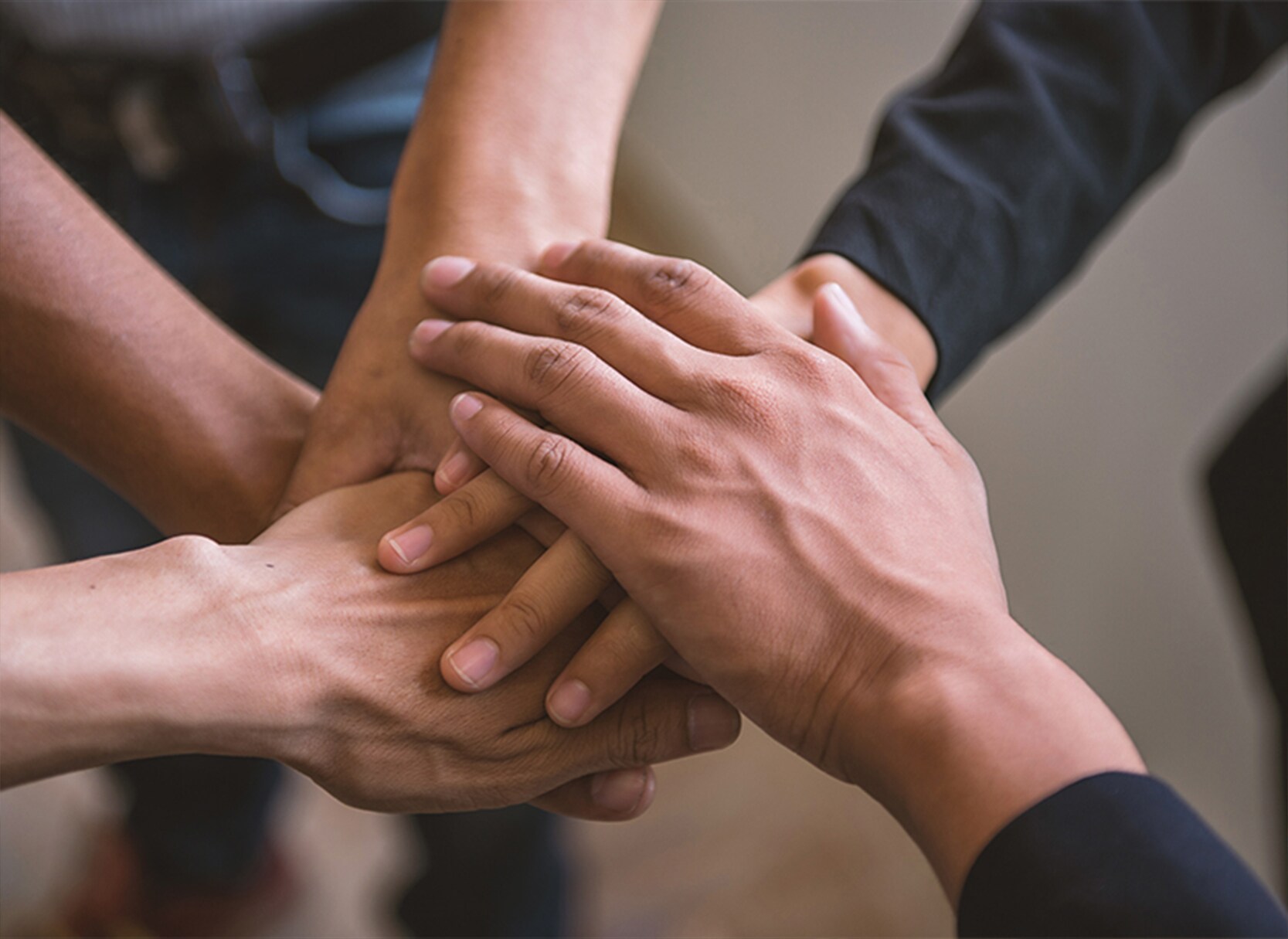 Four multiethnic hands together