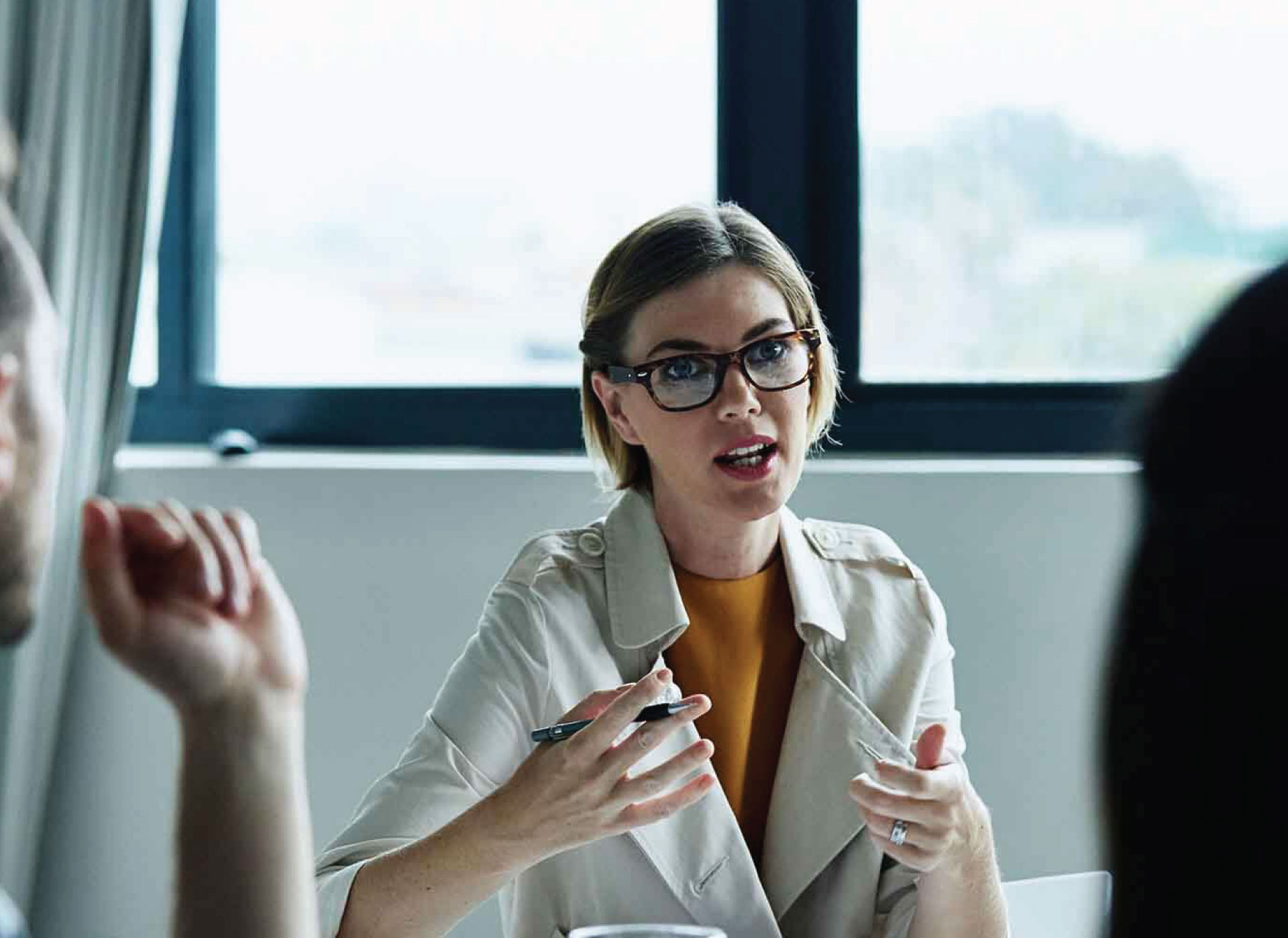 A group of people engaged in conversation during a meeting