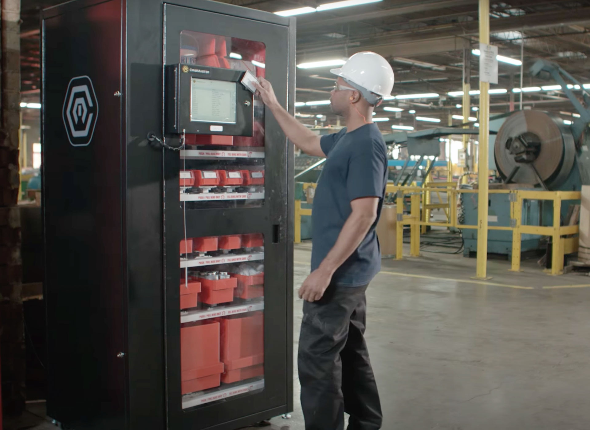 Employee using a CribMaster vending machine