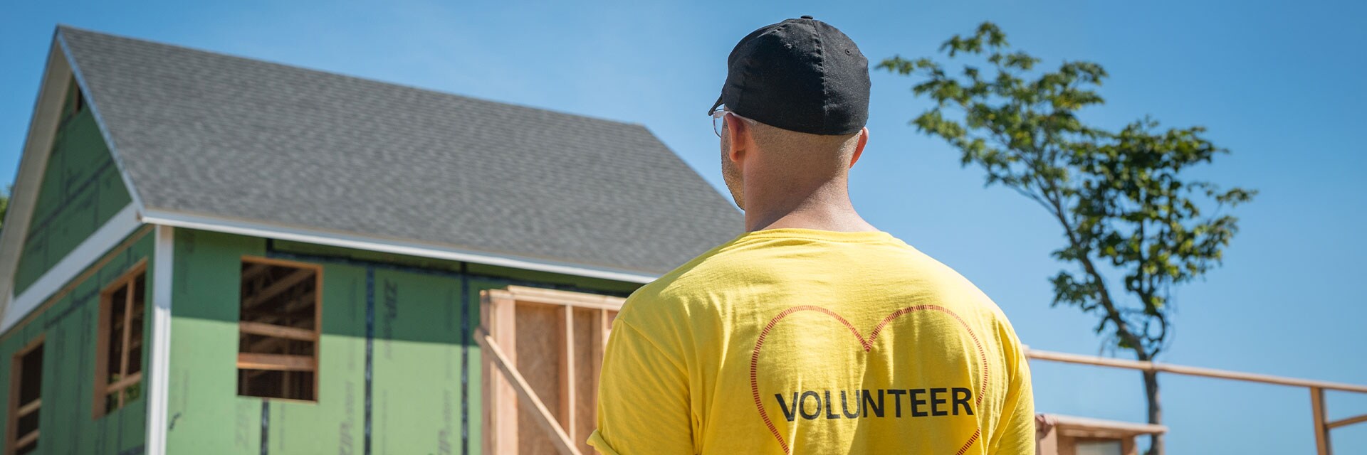 Stanley Black & Decker employee standing in front of a house build